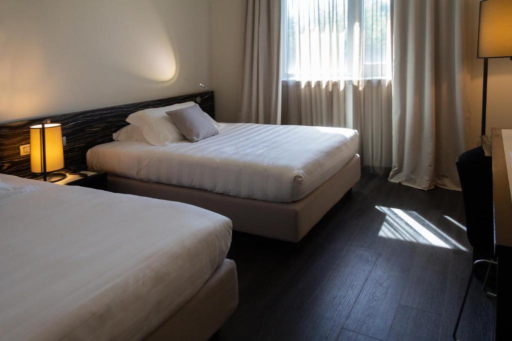 Postel nebo postele na pokoji v ubytování G Hotel Ancona