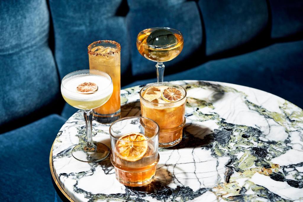 a group of drinks on a table with wine glasses at Hotel Continental in Oslo