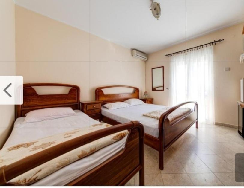 a bedroom with two beds in a room at Apartment Jovan2,on the beach with free Wi-Fi in Kotor