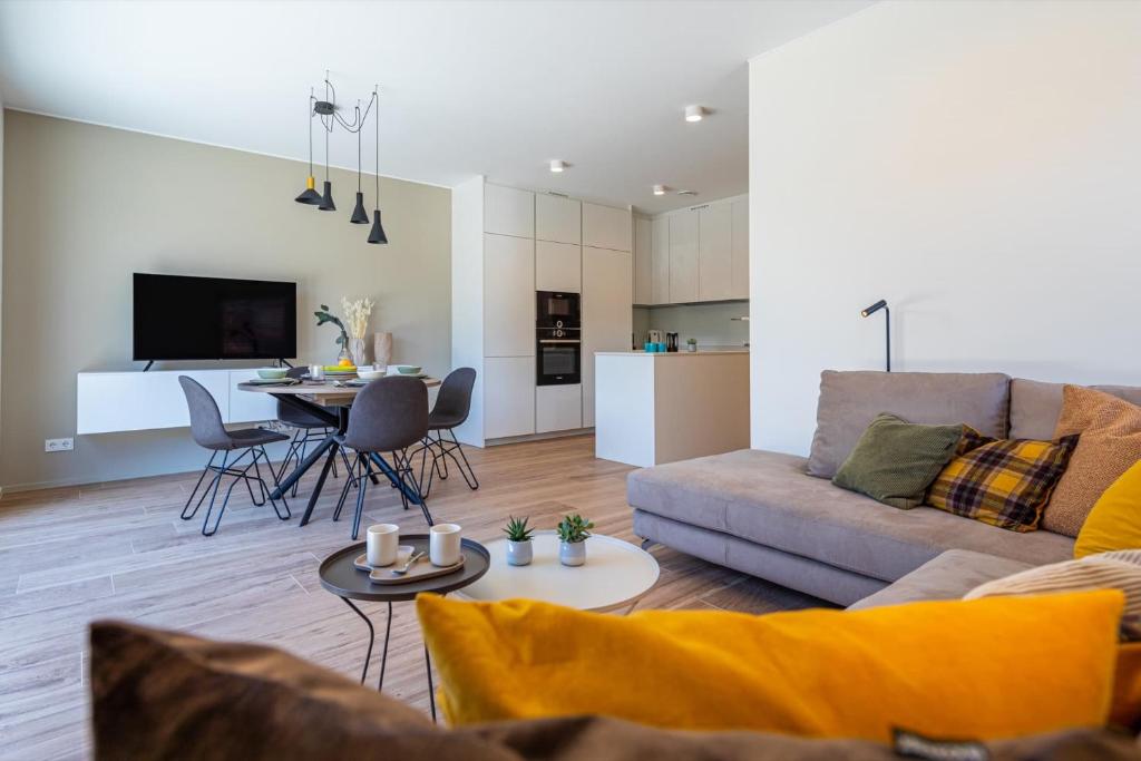 a living room with a couch and a table at Reckenthal House by Rentaroo in Luxembourg