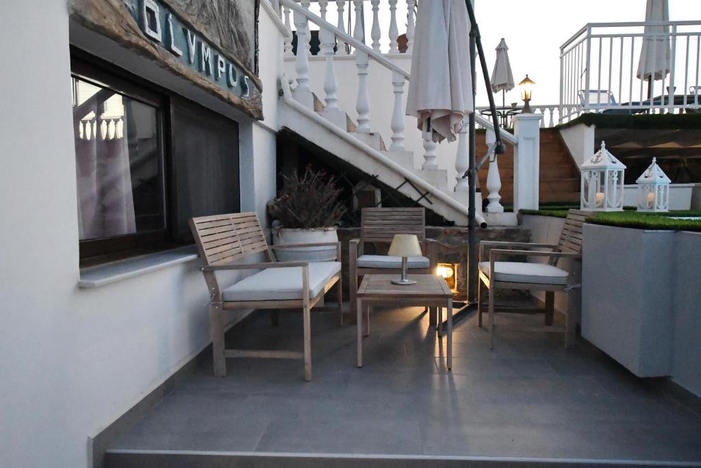 a group of chairs and a table on a balcony at Olympus Studios in Malia