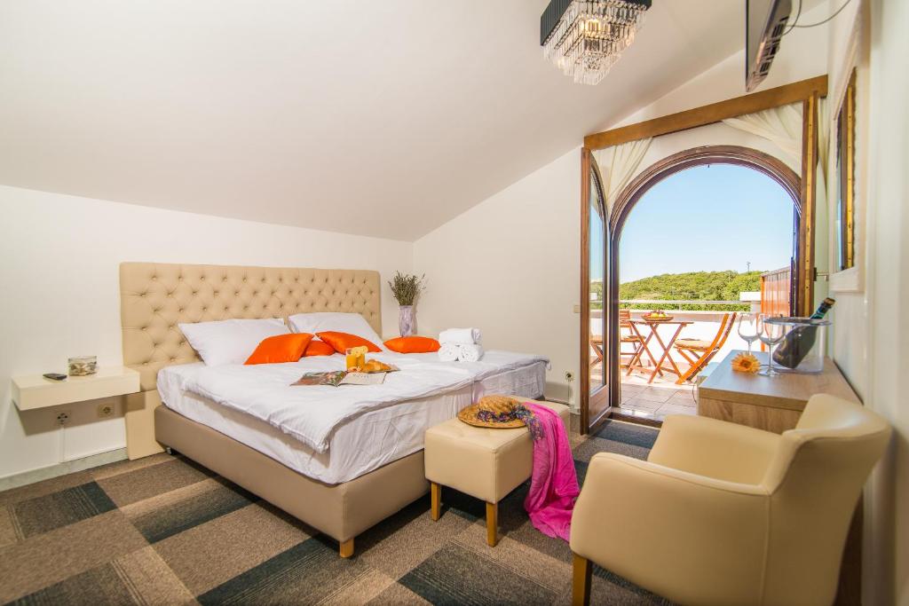 una camera con un grande letto e un balcone di Hotel Villa Vrsar a Vrsar