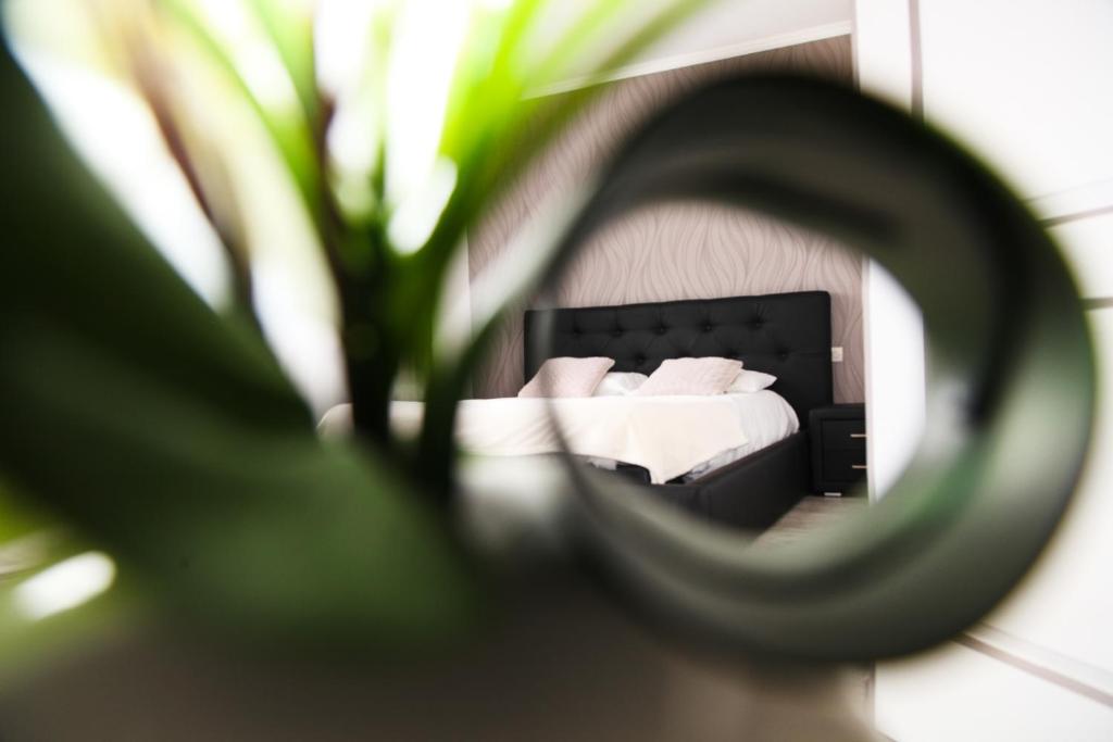 a bedroom with a bed in the reflection of a mirror at Hotel airport in Merville