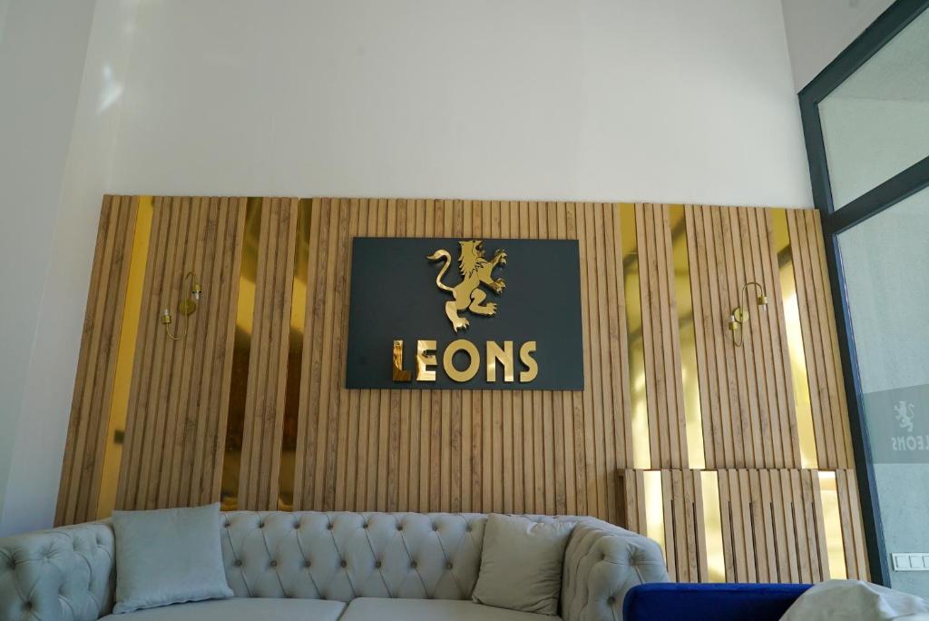 a couch in a room with a sign on the wall at LEONS HOTEL in Canakkale