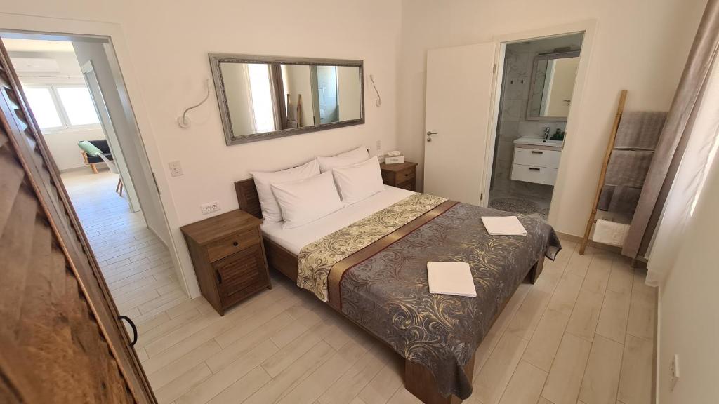 a small bedroom with a bed and a mirror at Apartments Tanja in Zavalatica