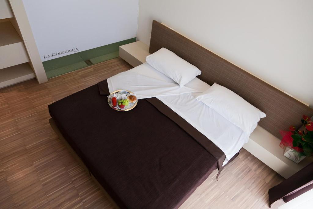 Postel nebo postele na pokoji v ubytování Hotel La Conchiglia