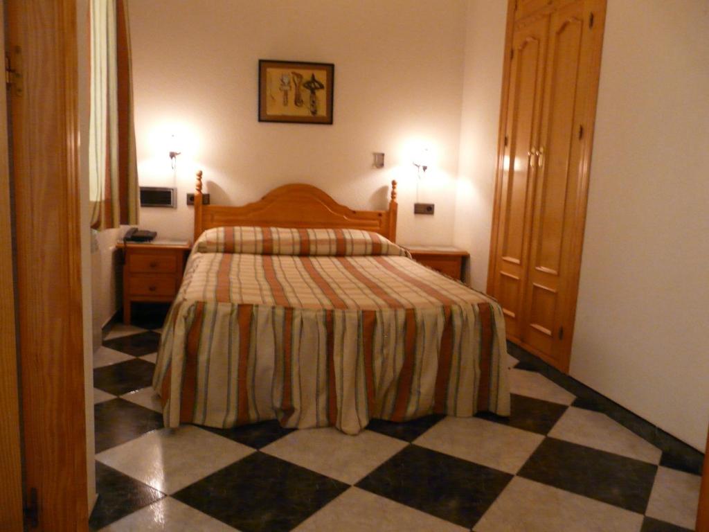 Postel nebo postele na pokoji v ubytování Hotel Guillermo II
