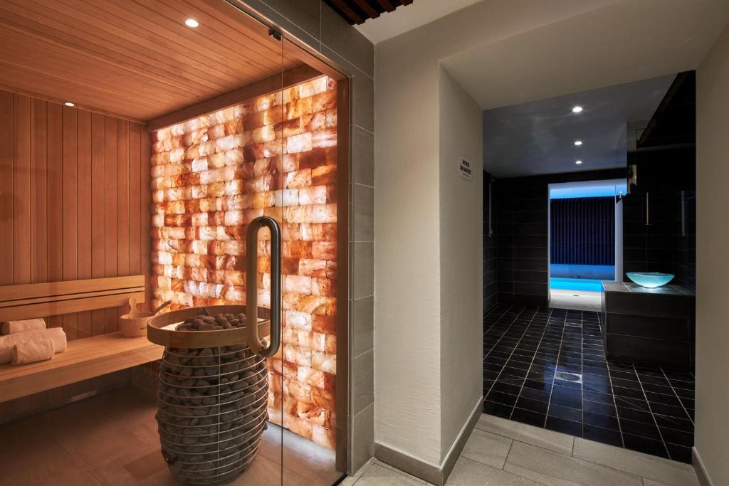 a bathroom with a shower with a brick wall at Hotel Villa Romantic & Spa in Paris