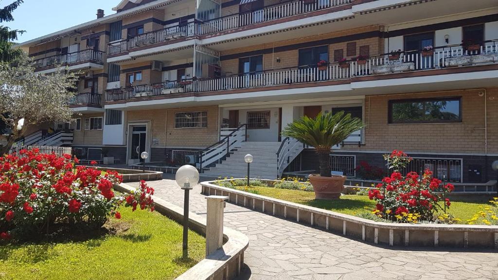 a large building with flowers in front of it at Mostacciano Roma IFO in Rome