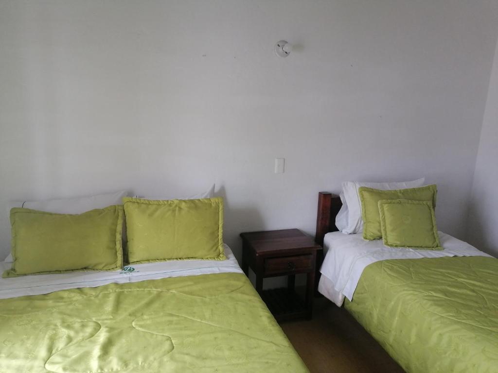 Giường trong phòng chung tại Hotel Beraka Boutique