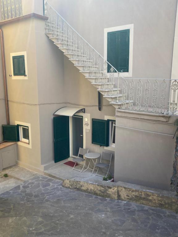 a staircase in a building with a table and chairs at Appartamento TERESA in Rio nellʼElba