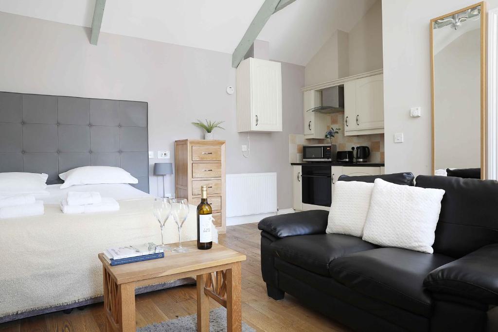 a living room with a bed and a couch at Avocet Cottage in Lucker