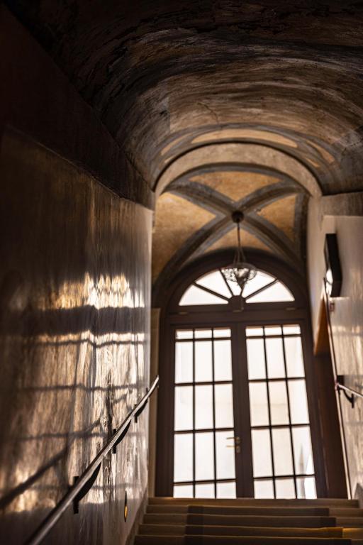 a hallway with a large window and stairs in a building at Hotel Dei Dragomanni in Venice