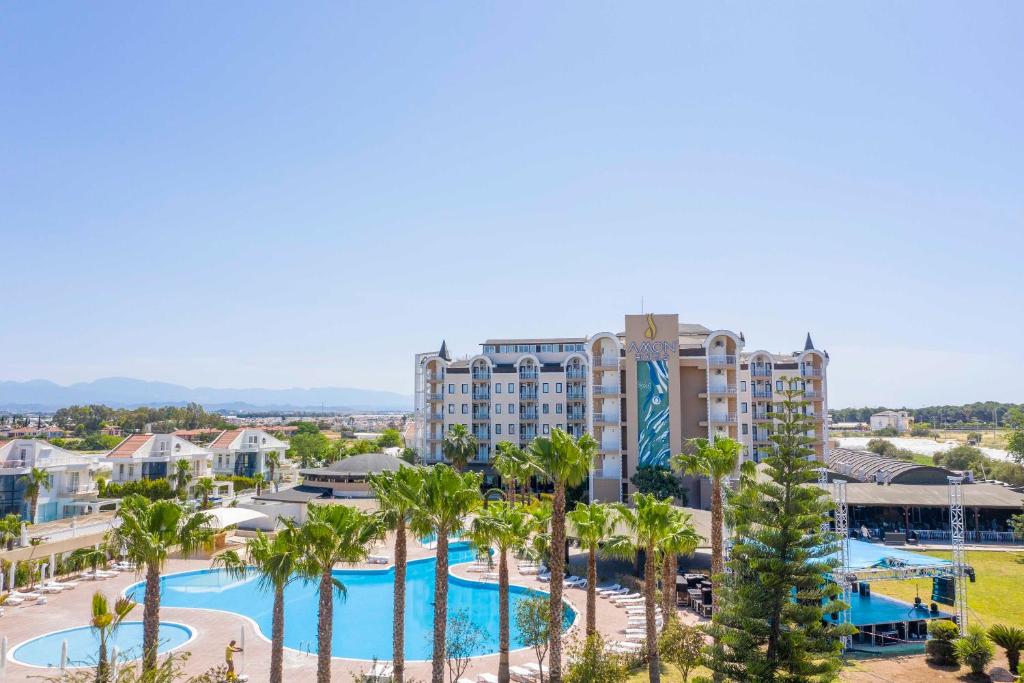 an aerial view of a resort with a pool and palm trees at Amon Hotel Belek in Belek