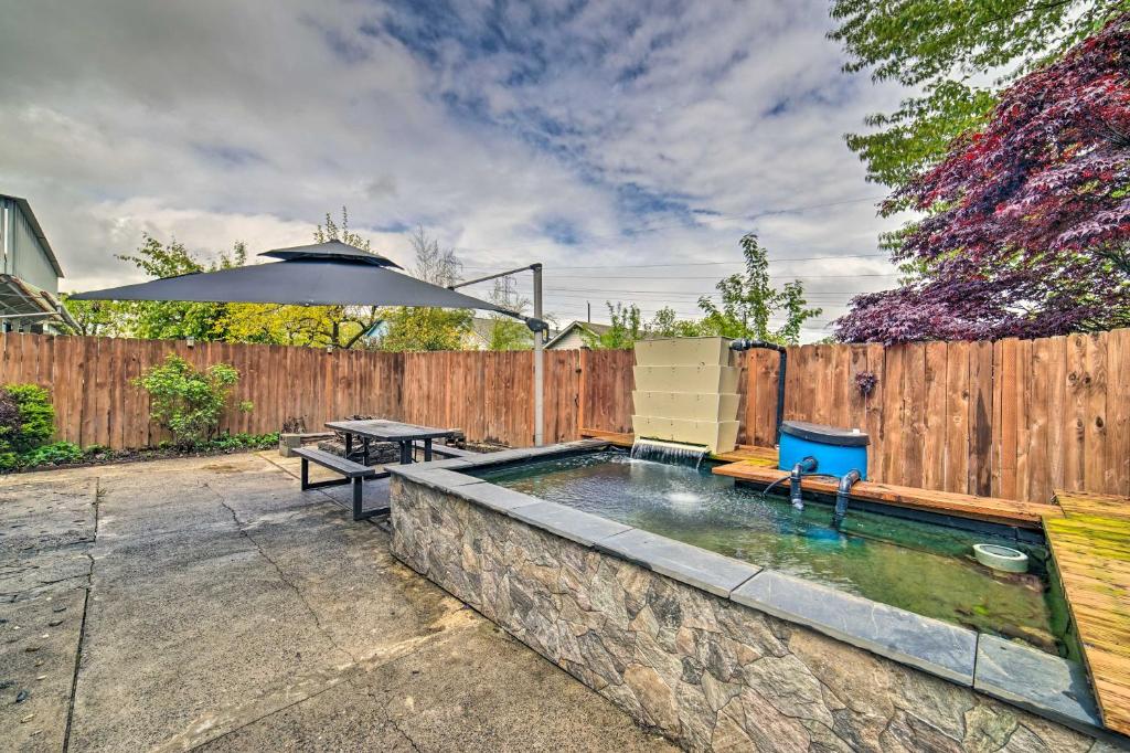 a backyard with a swimming pool and an umbrella at Modern Seattle Home 9 Mi to Dtwn Attractions in Seattle