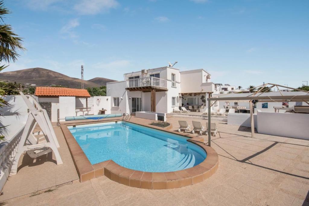 a swimming pool on a patio with a house at Casa Nira in Mácher