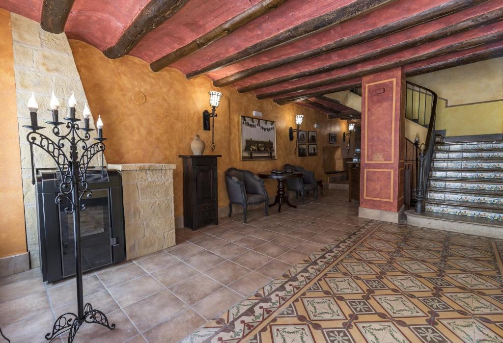 a living room with a fireplace and a table at Casa Rural La Cuca in Lerín