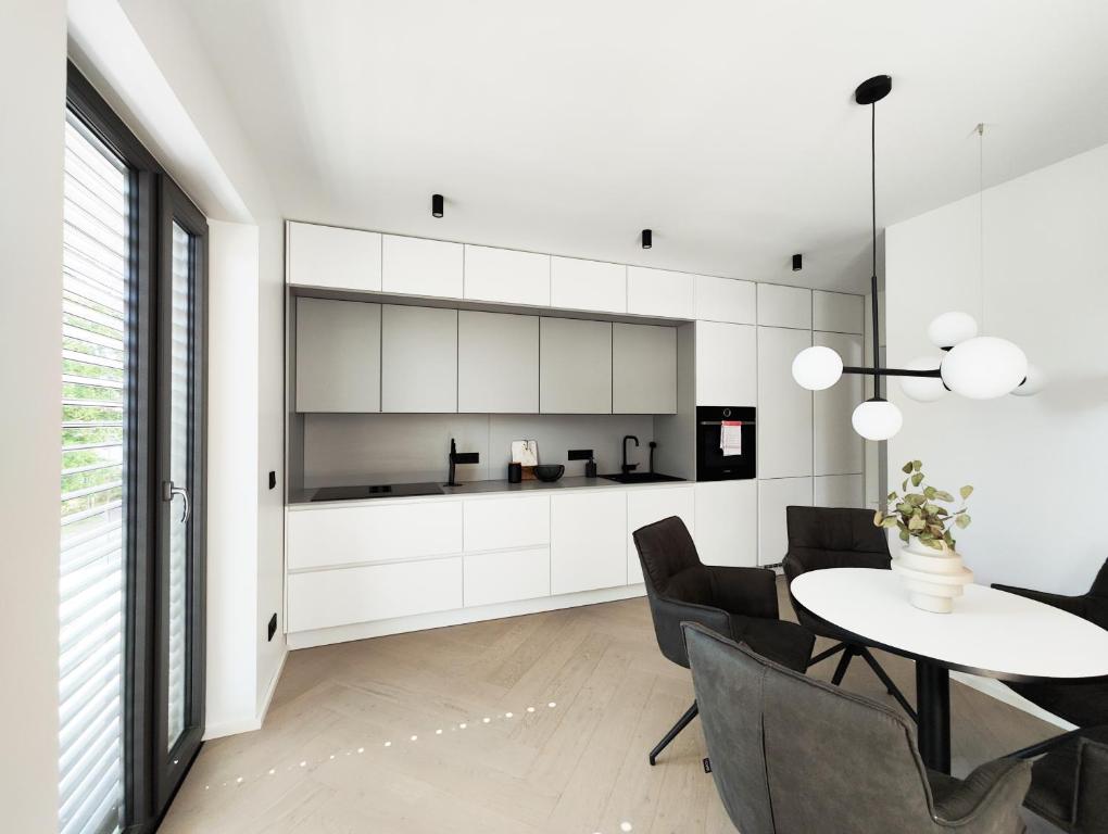 a kitchen and dining room with a table and chairs at Ferienhaus Stadtblick in Bad Marienberg