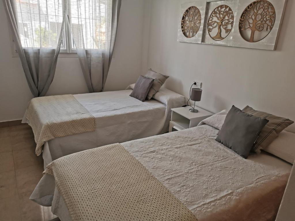 Postel nebo postele na pokoji v ubytování Manilva House