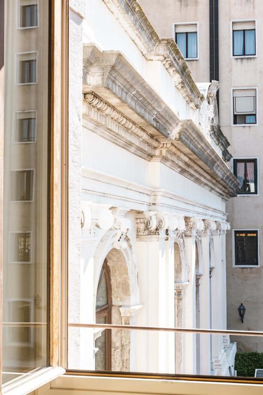 a view of a building through a window at Hotel Dei Dragomanni in Venice