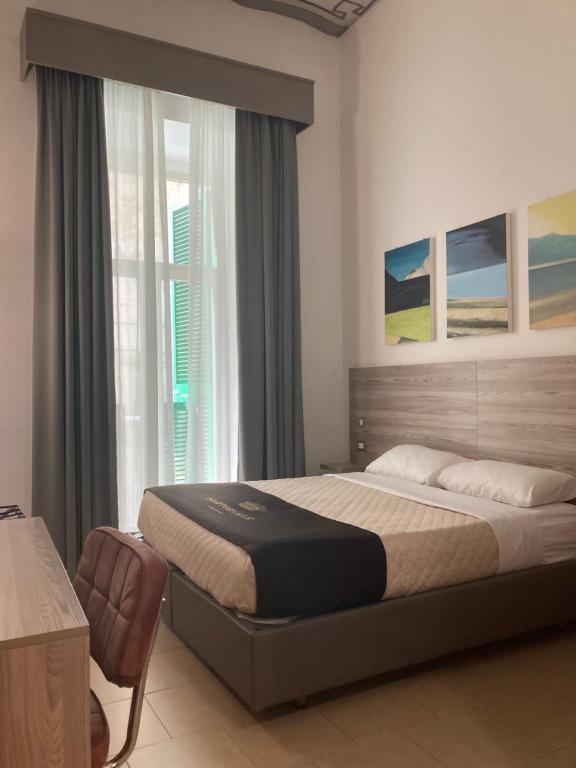 a bedroom with a large bed and a window at 4STANZE in Naples