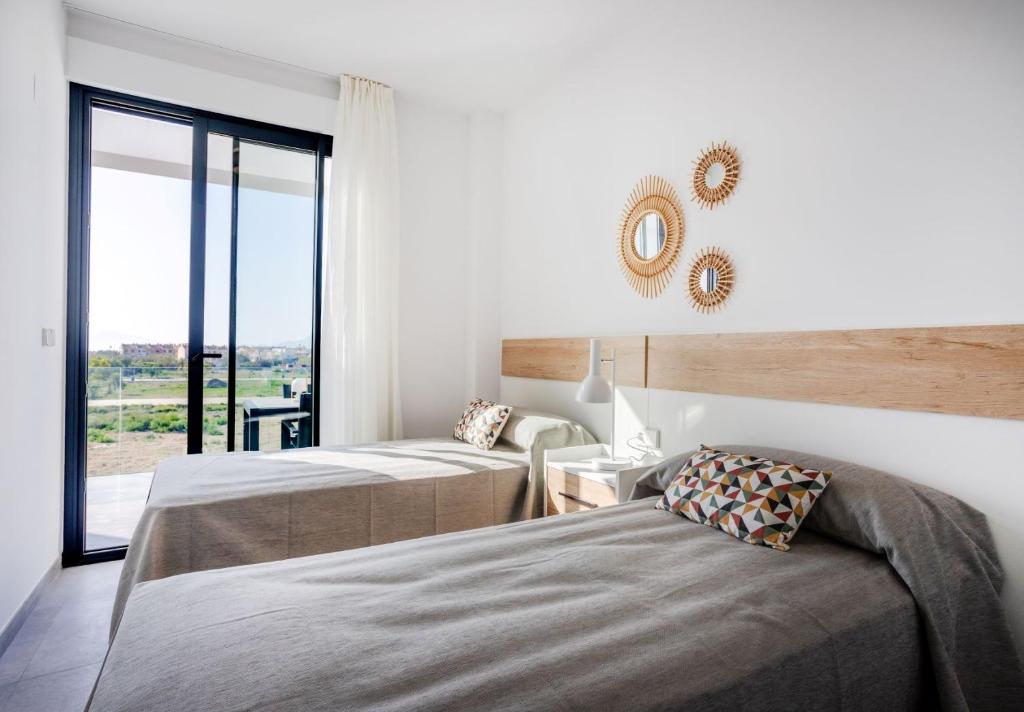 Postel nebo postele na pokoji v ubytování Oliva Suites