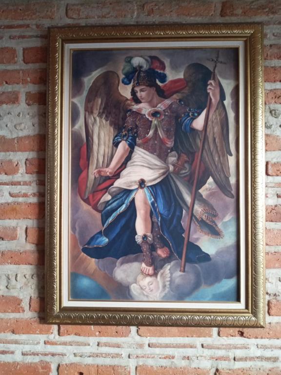 a painting of an angel on a brick wall at Casa Tapalpa in Tapalpa