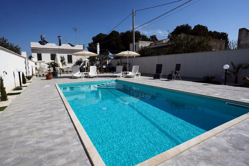 a swimming pool with blue water in a house at Villa Giulia in Marinella di Selinunte