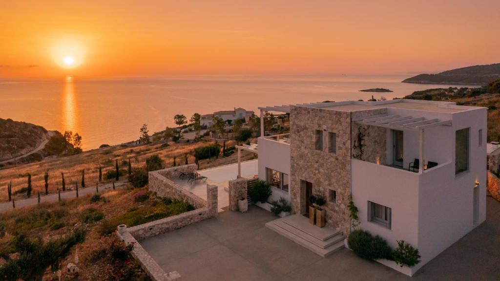 an aerial view of a house with the sunset in the background at Avgi holiday villa in Agios Nikolaos