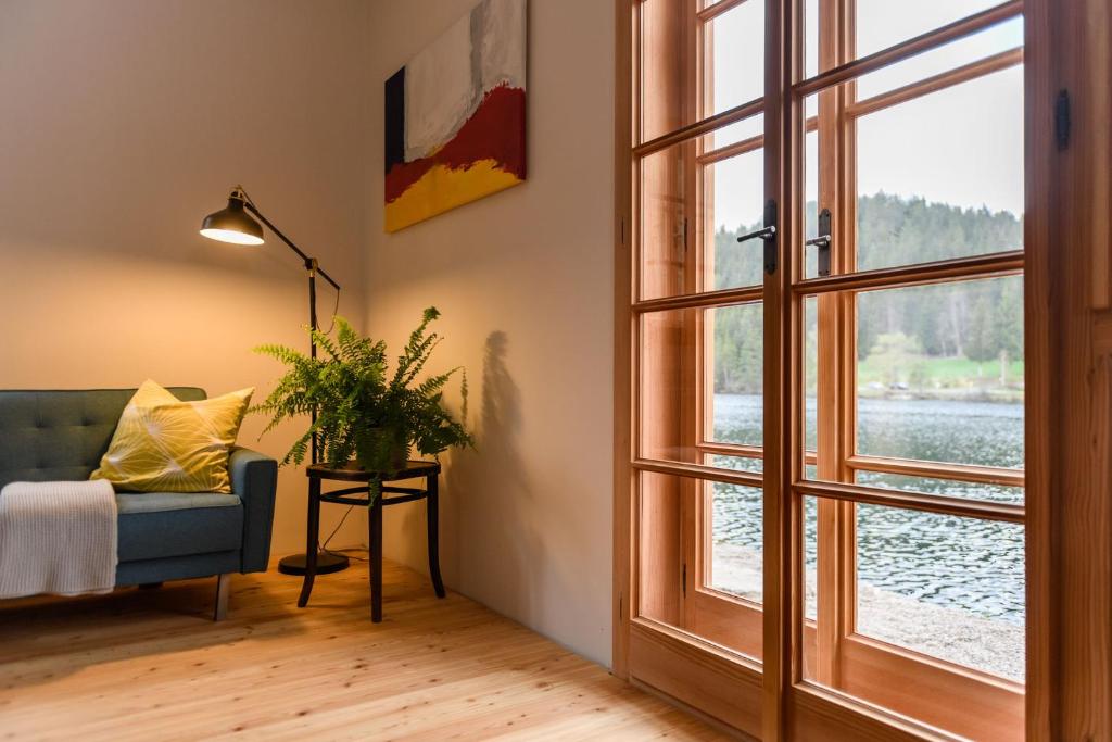 a living room with a blue couch and a window at Seehaus Walster10 in Mariazell