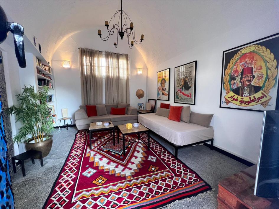 a living room with a couch and a rug at OLIVIA Guest House (Eya & Abbes) in Sidi Bou Saïd