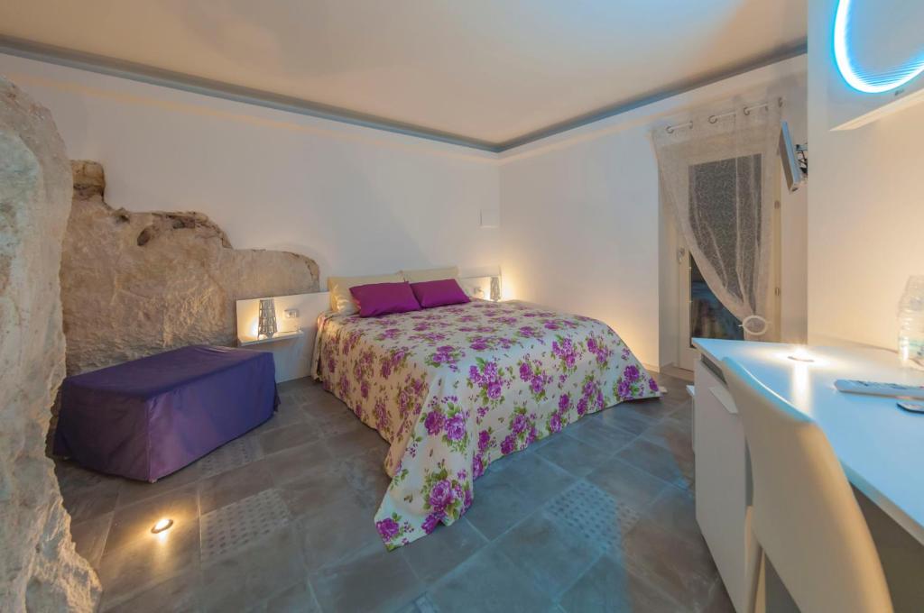 a bedroom with a bed and a blue counter at Terrazza Santa Barbara in Matera