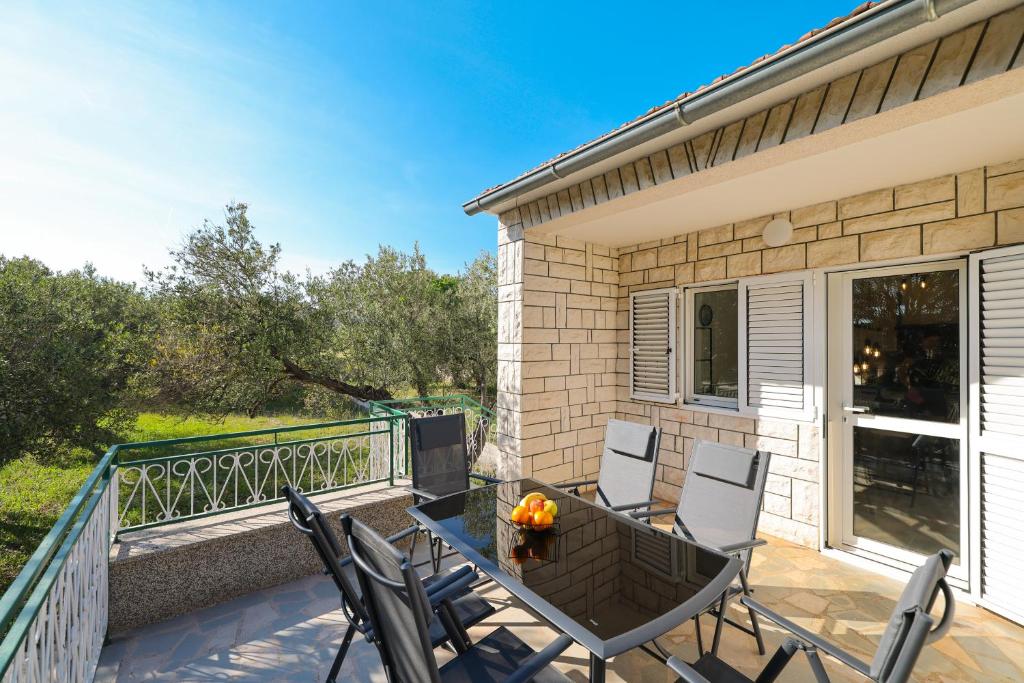a patio with chairs and a table on a balcony at Holiday house Antulov in Vodice