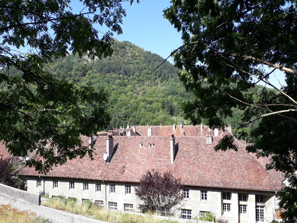 a large white building with a red roof at O'Couvent - Appartement 77 m2 - 2 chambres - A321 in Salins-les-Bains