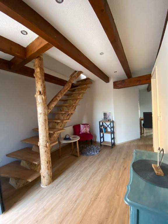 a living room with a spiral staircase in the ceiling at Ferienwohnung an der Unditz 3 in Neuried