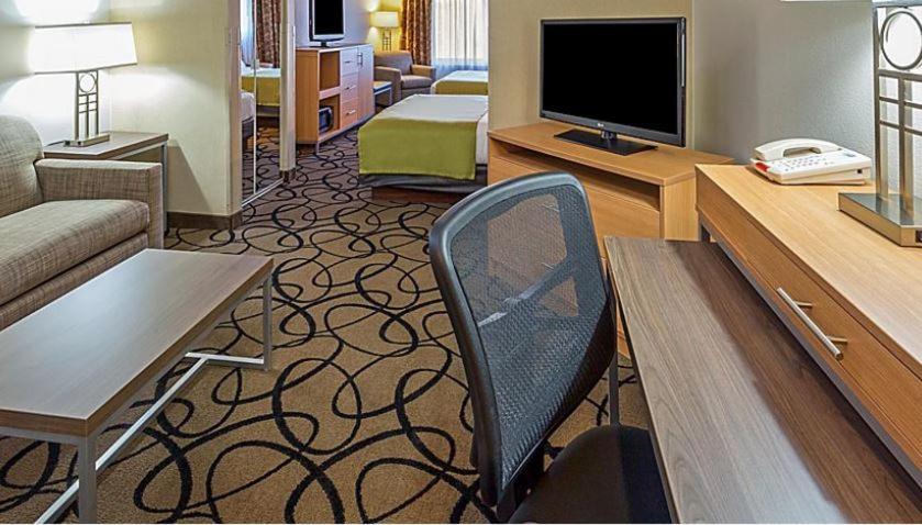 a living room with a couch and a chair in a hotel room at Holiday Inn Express & Suites - Henderson South - Boulder City, an IHG Hotel in Henderson