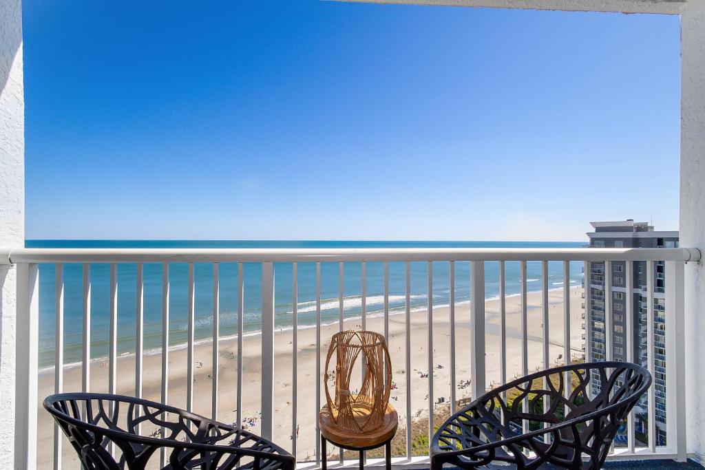 uma varanda com 2 cadeiras e vista para a praia em Ocean Breeze em Myrtle Beach