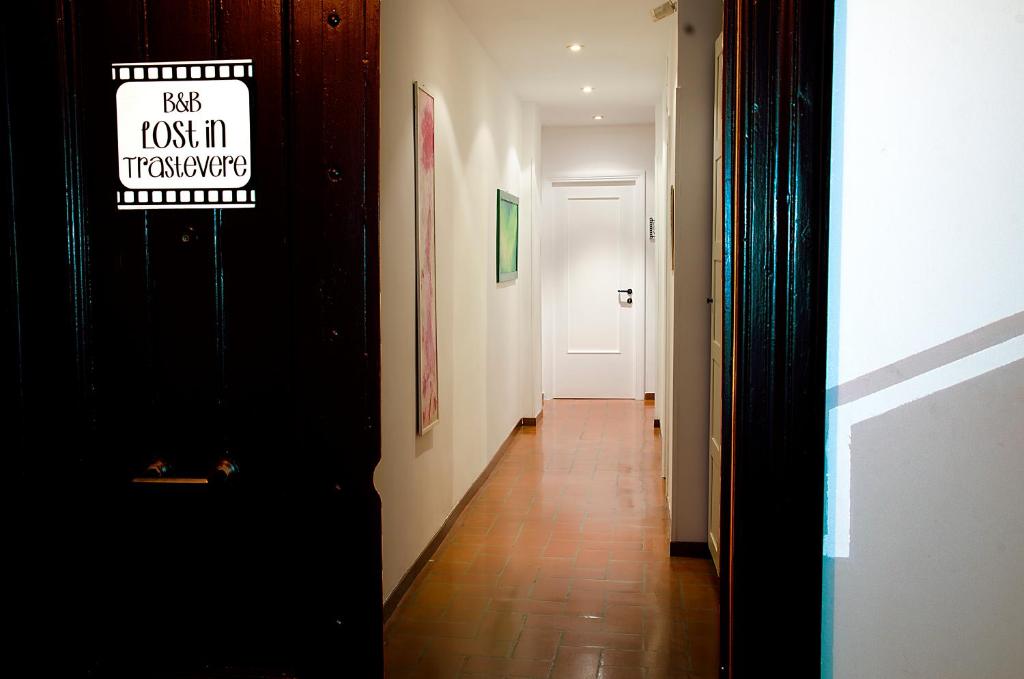 a hallway with a door with a sign on it at B&B Lost in Trastevere in Rome