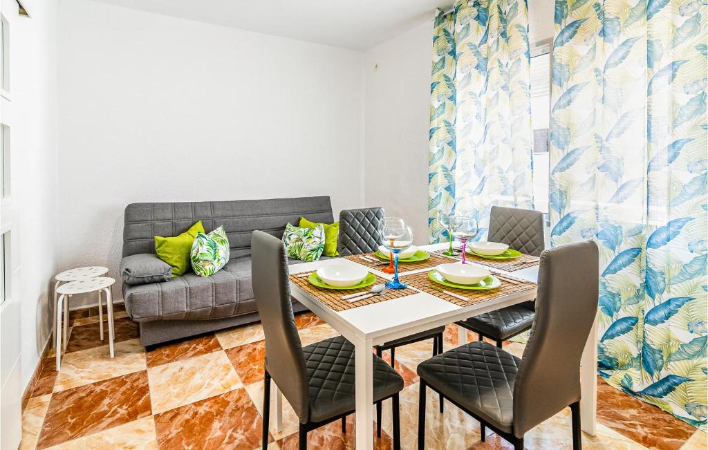 a dining room with a table and chairs and a couch at Gorgeous Apartment In Cordoba With Wifi in Córdoba