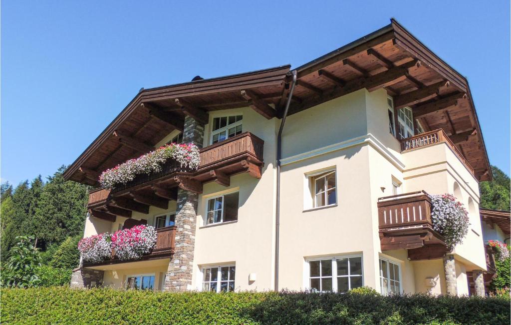 a house with balconies and flowers on it at Ferienwohnung In Ruhiger Lage in Brixen im Thale