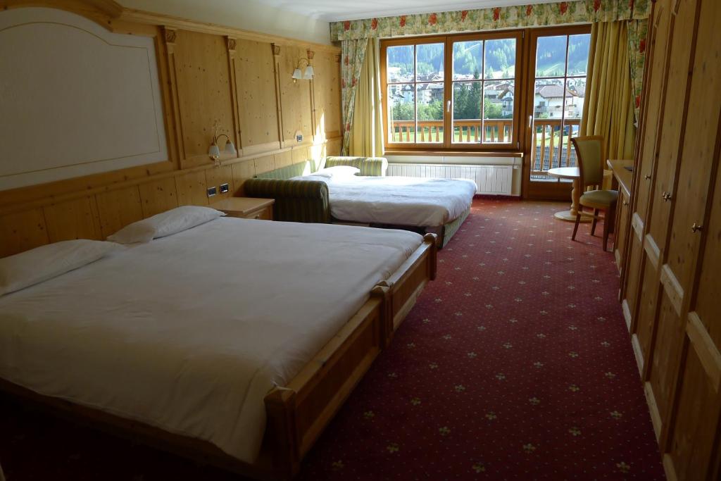 Postel nebo postele na pokoji v ubytování TH Corvara - Greif Hotel