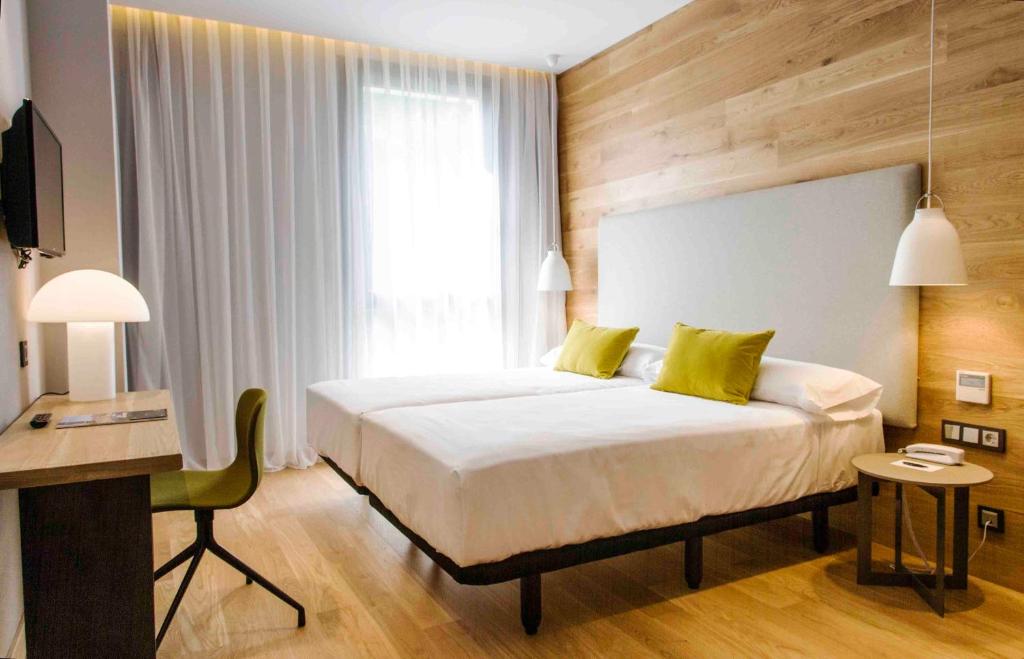 Cama o camas de una habitación en Zenit San Sebastián