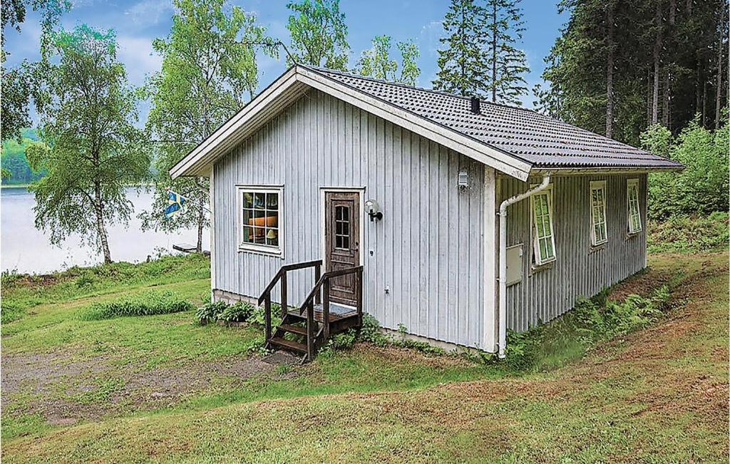 a small white building on the side of a hill at Lovely Home In Fjrs With House Sea View in Vågerse