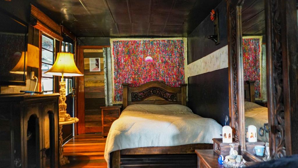 ein Schlafzimmer mit einem Bett und einem Tisch mit einer Lampe in der Unterkunft Palu Ecoaldea reserva forestal in Tenjo