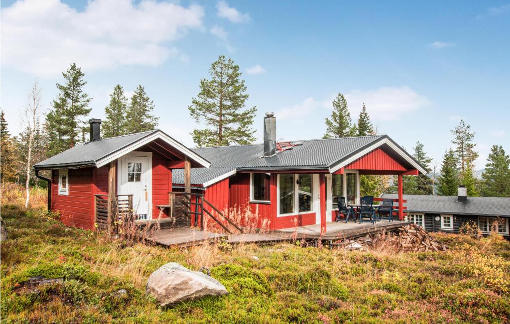 a red house on top of a hill at Stunning Home In Trysil With 5 Bedrooms, Sauna And Internet in Trysil