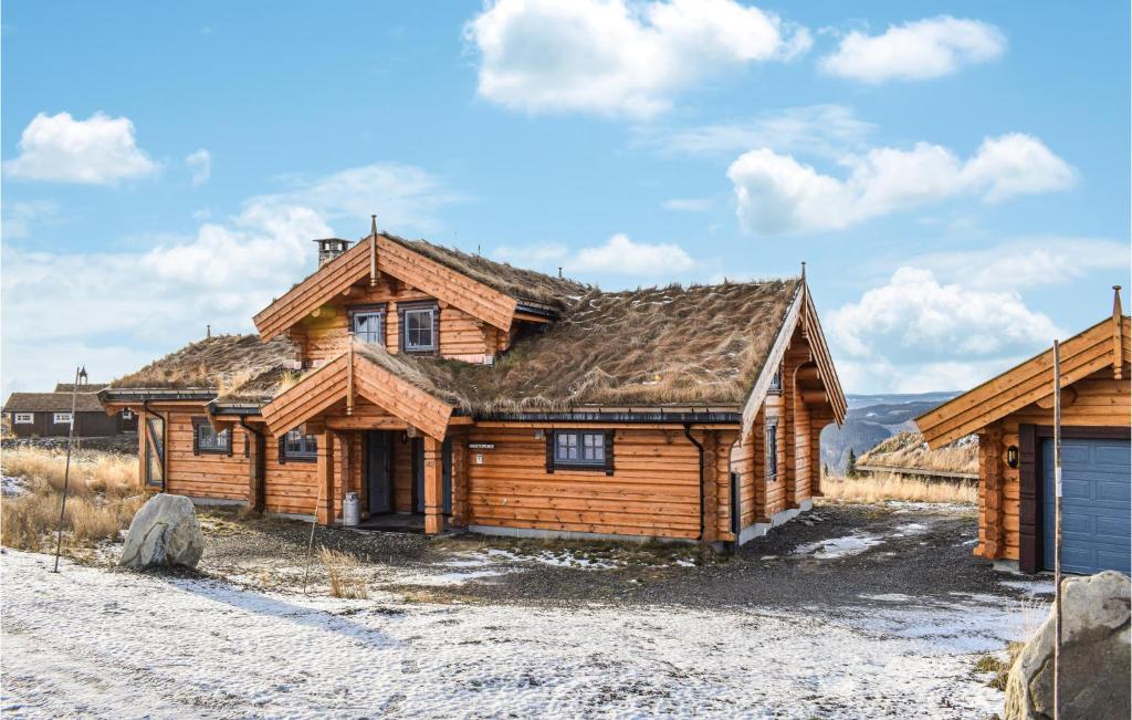a log house in the middle of a field at Beautiful Home In yer With Sauna, 5 Bedrooms And Wifi in Øyer