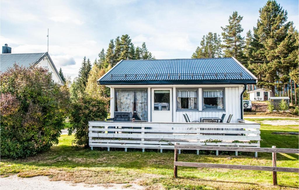 a white tiny house with a blue roof at 2 Bedroom Lovely Home In Atna in Atnoset