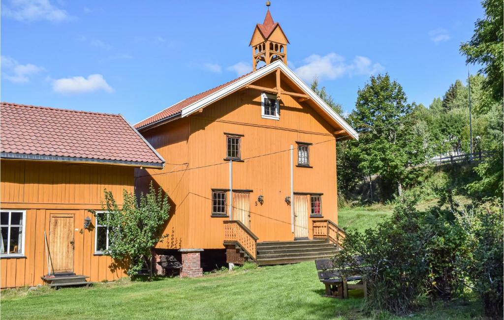 an orange building with a clock tower on top of it at Bjertnes Turistgrd in Noresund