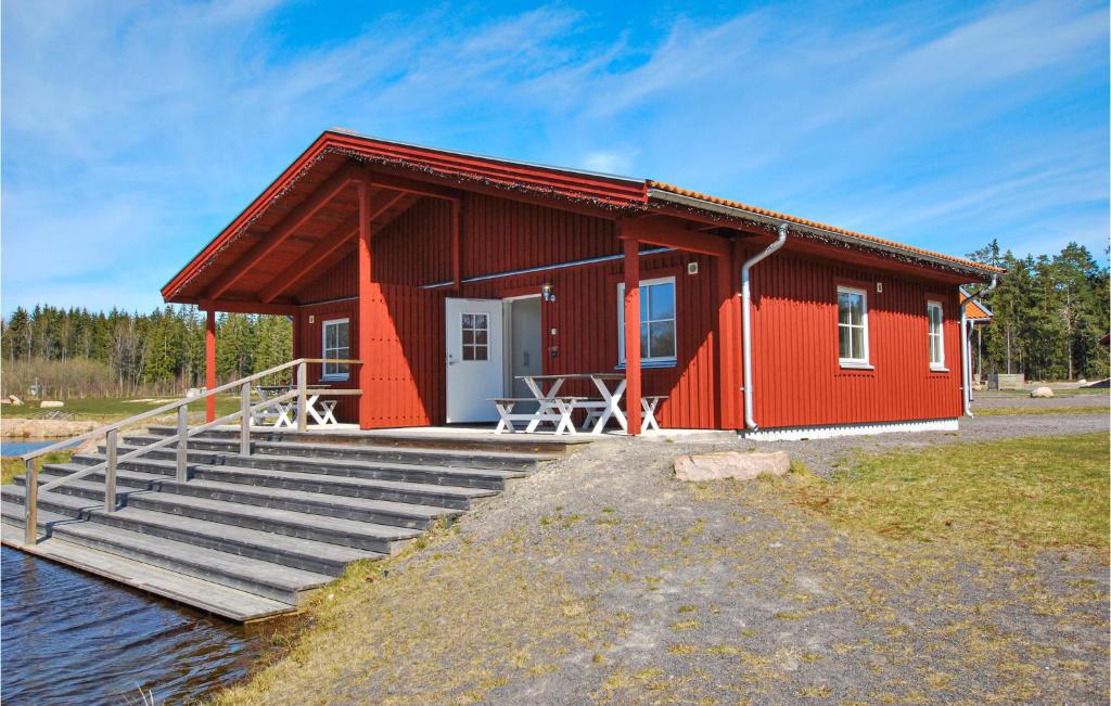 a red house with stairs leading to it at Awesome Home In Kosta With Wifi in Kosta
