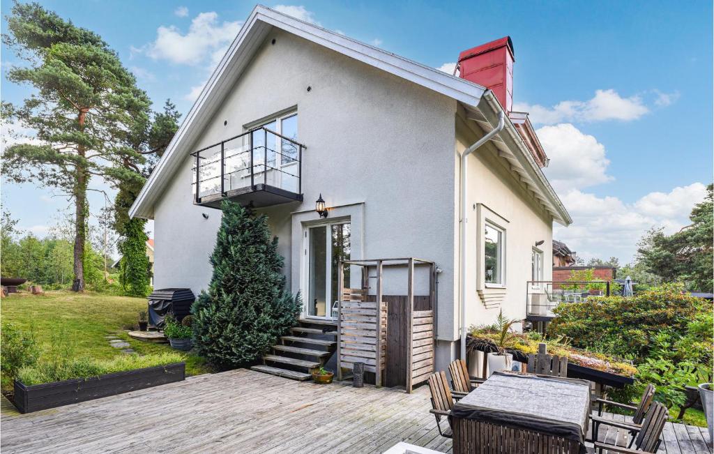 哥特堡的住宿－Stunning Home In Gteborg With Sauna，白色的房子,设有门廊和甲板